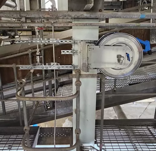 High-pressure stainless steel hose reel and trigger gun mounted to a support column as part of the washdown system at an industrial site in Burton.